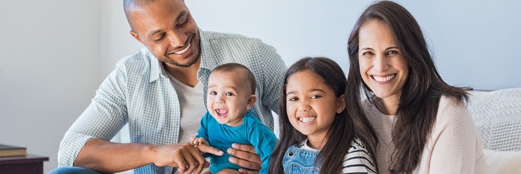 webpage_sidekick African American family sitting on couch
