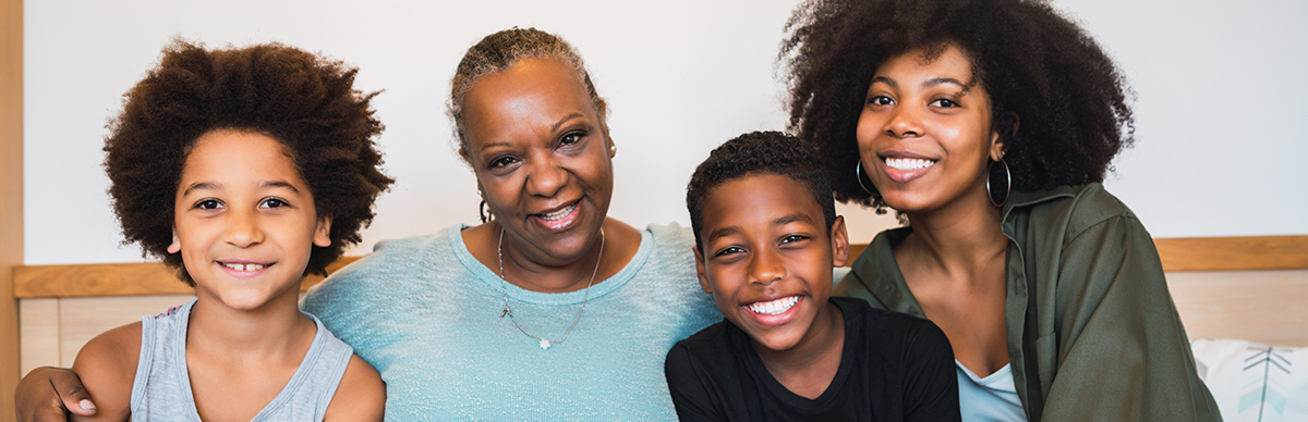 webpage_sidekick African American family sitting on couch