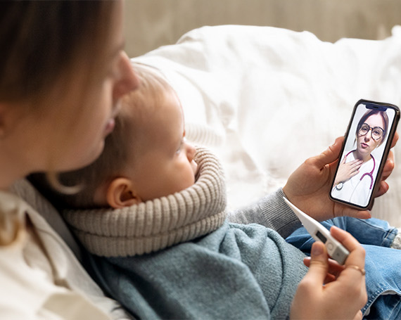 Mother with sick child doing telehealth visit